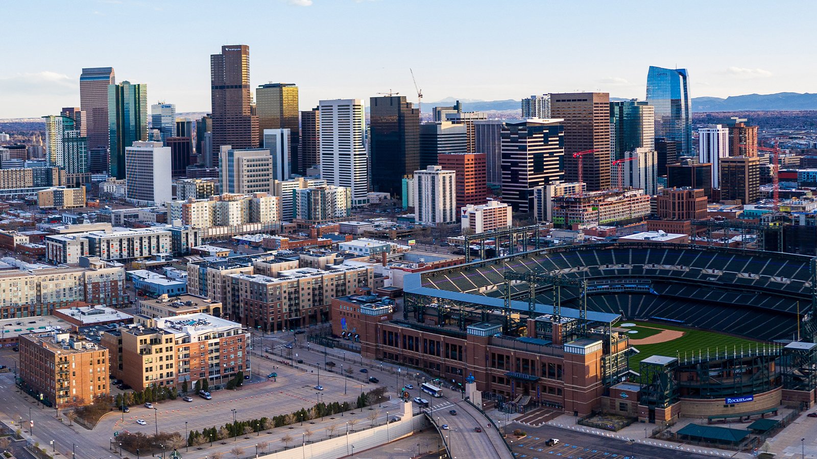 An image of the Denver skyline with Coors Field in the foreground.