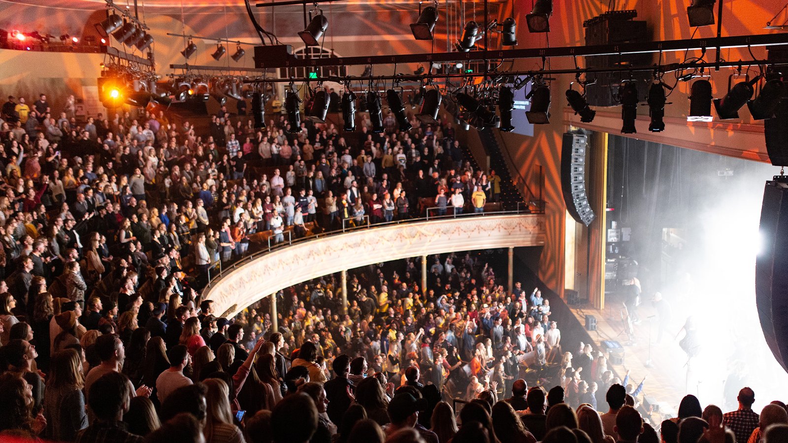 Crowd standing while watching a concert at the Ryman Auditorium in Nashville.