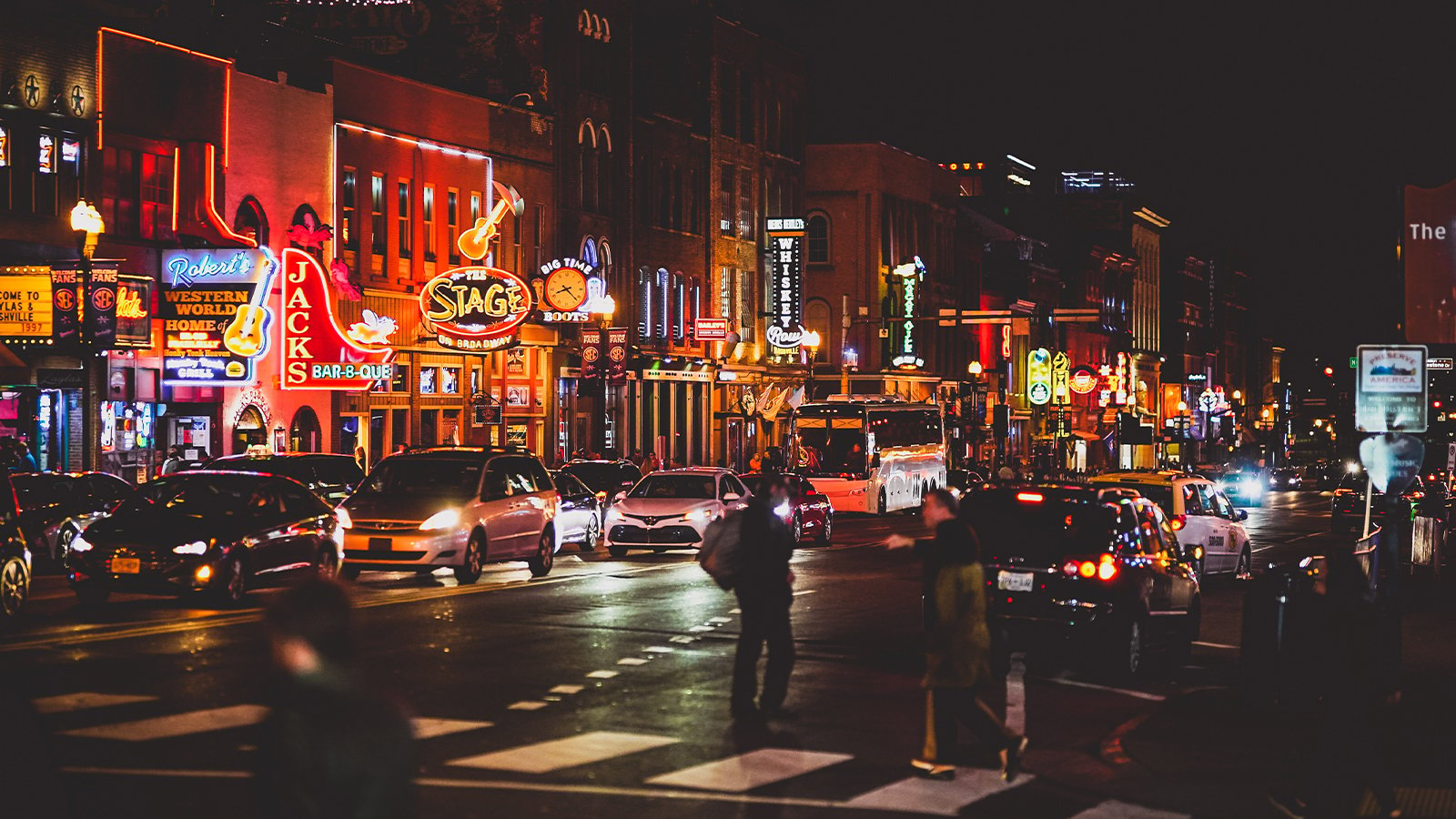 Broadway Street in downtown Nashville full of people and cars.