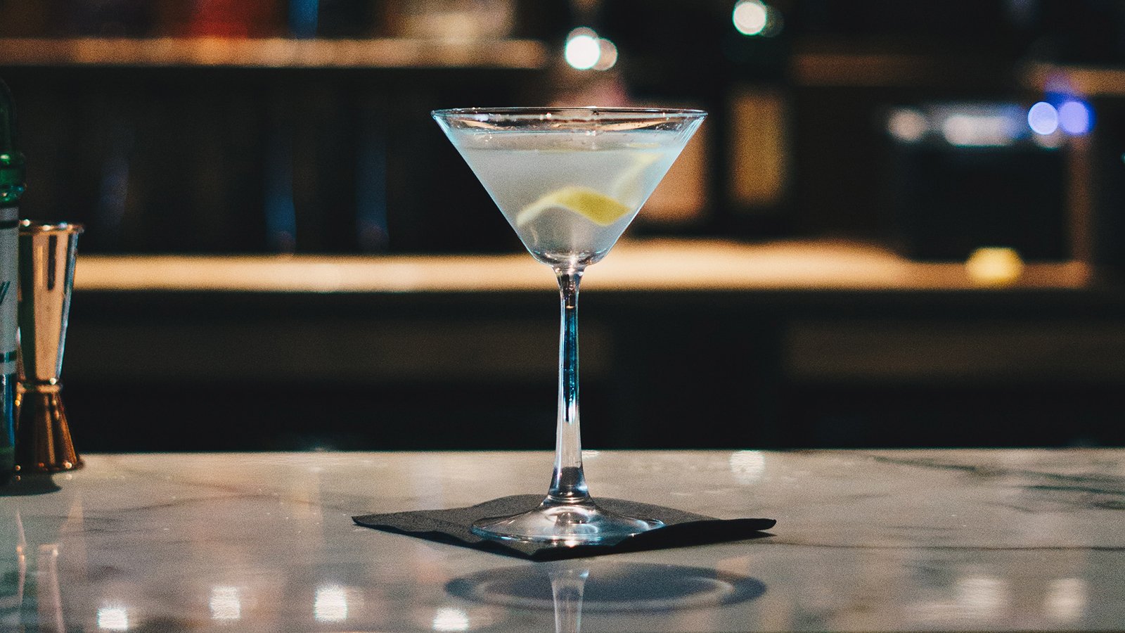 A closeup of a cocktail sitting on a bar.