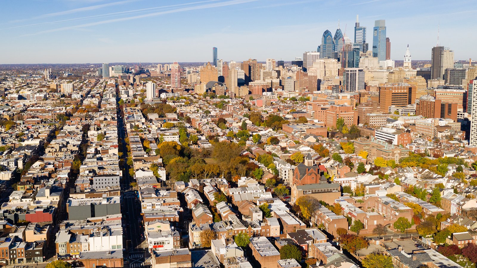 The skyline of Philadelphia with densely populated neighborhoods in the foreground.