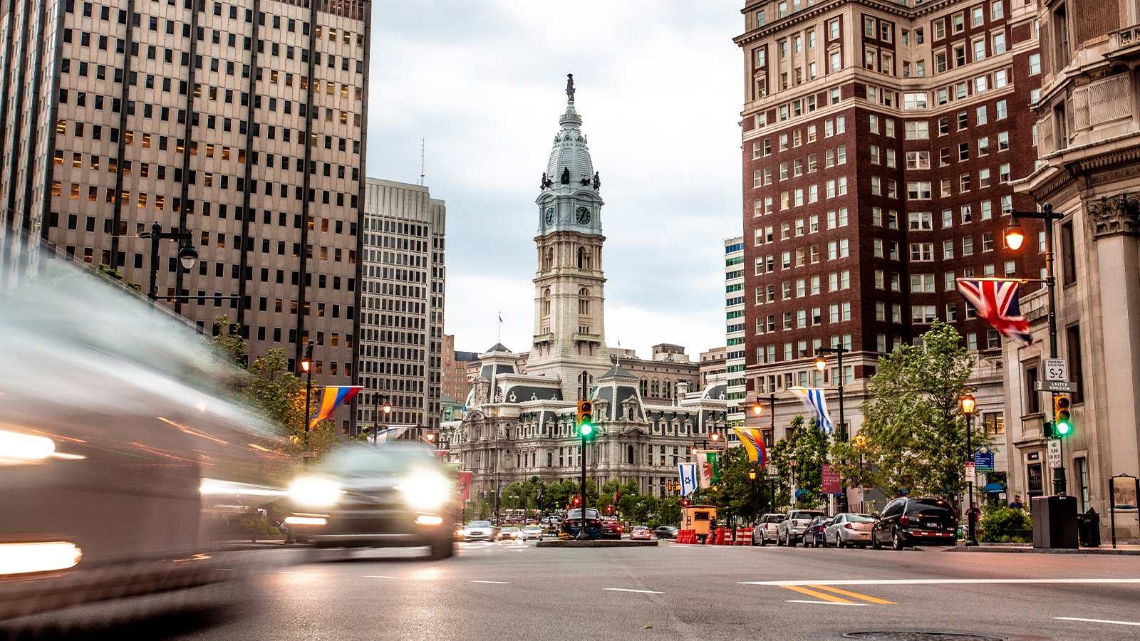 A street level view of Philadelphia with City Hall in the background.