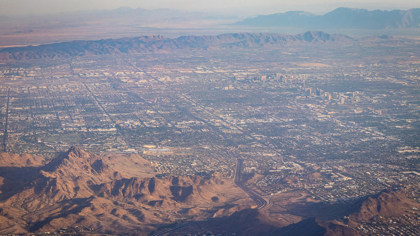 Aerial view of the city of Phoenix and surrounding desert landscape.