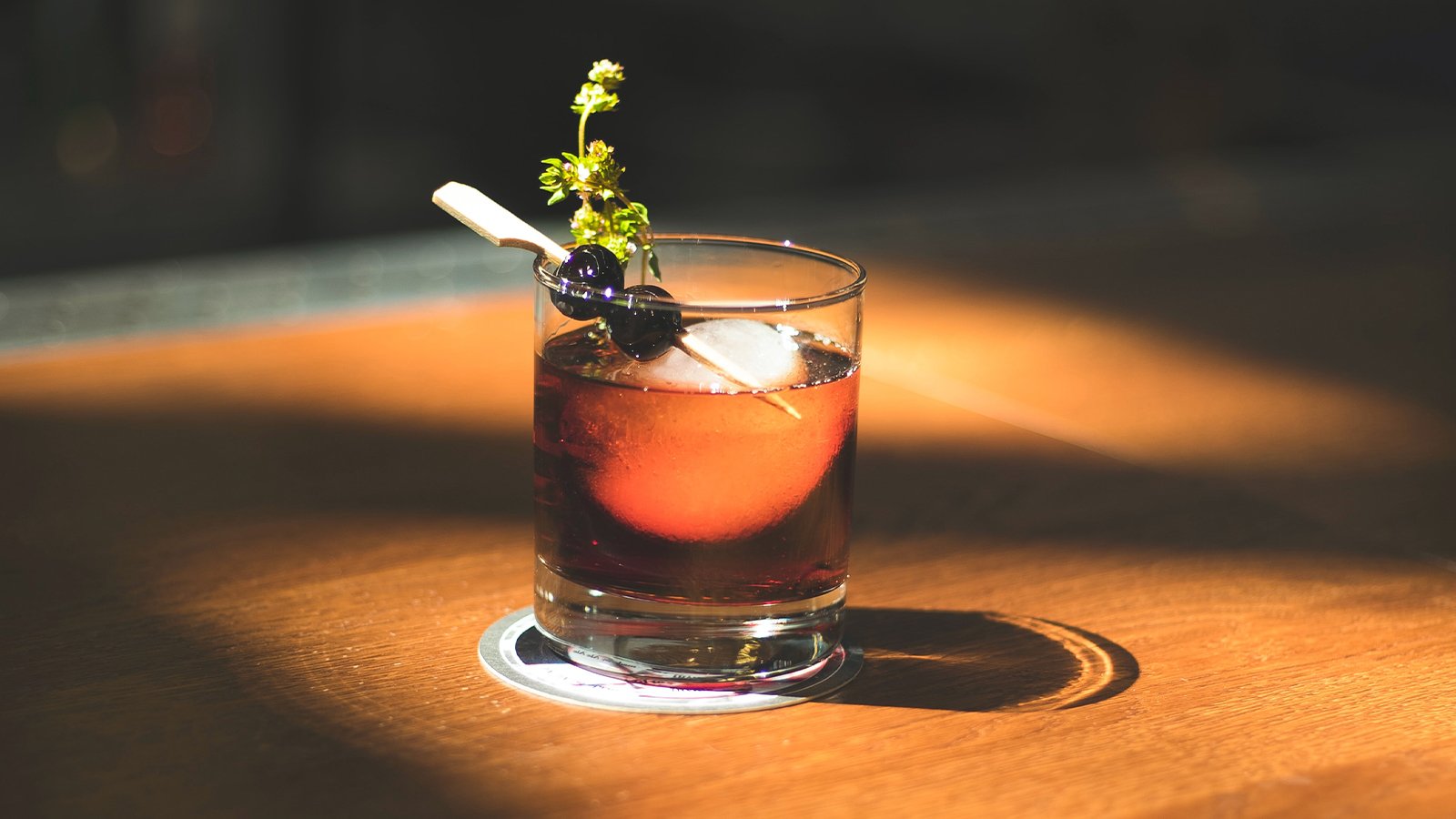 An image of a cocktail sitting on a wooden table.
