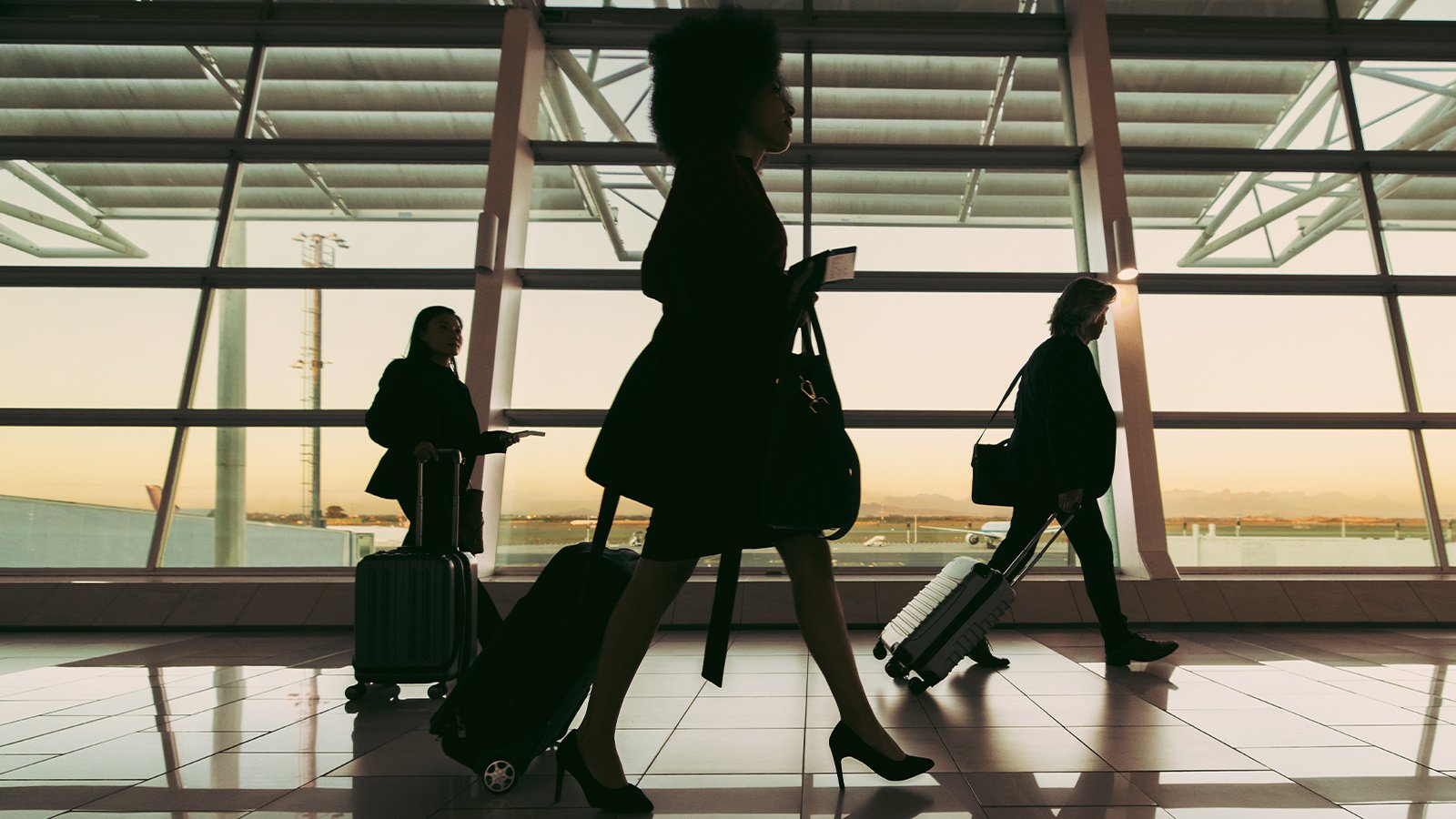 Silhouette of people walking at airport terminal