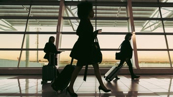 Silhouette of people walking at airport terminal