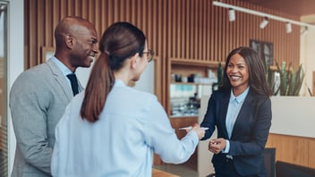business travelers checking in at hotel