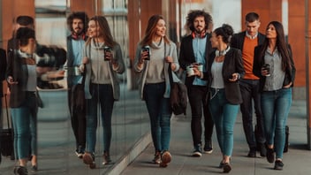 Business colleagues walking and talking on city streets