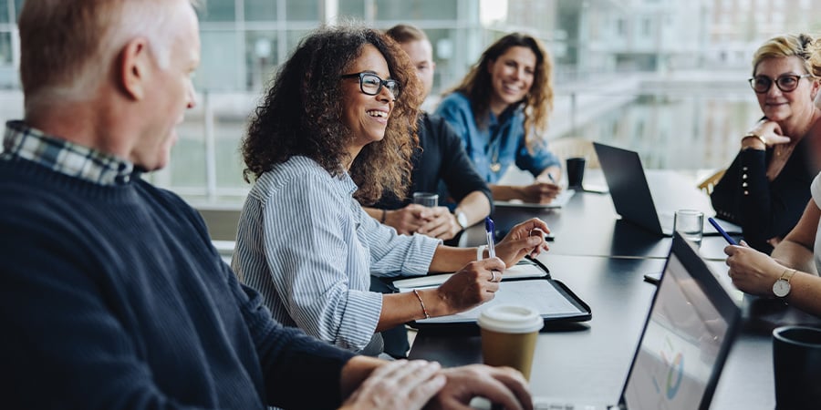 A corporate business team talking around a conference table