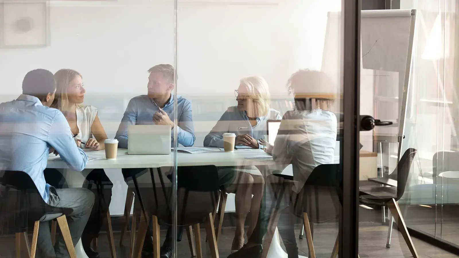 A group of people sitting inside a conference room