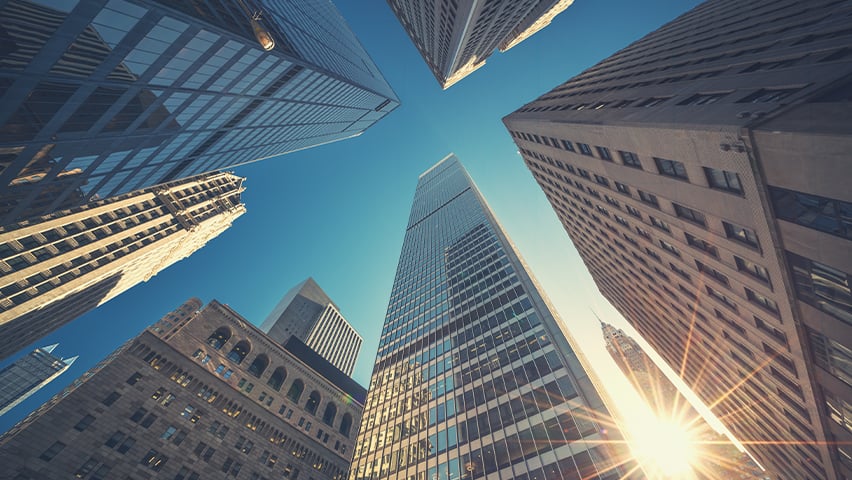 A view looking up at high rise buildings in Manhattan.