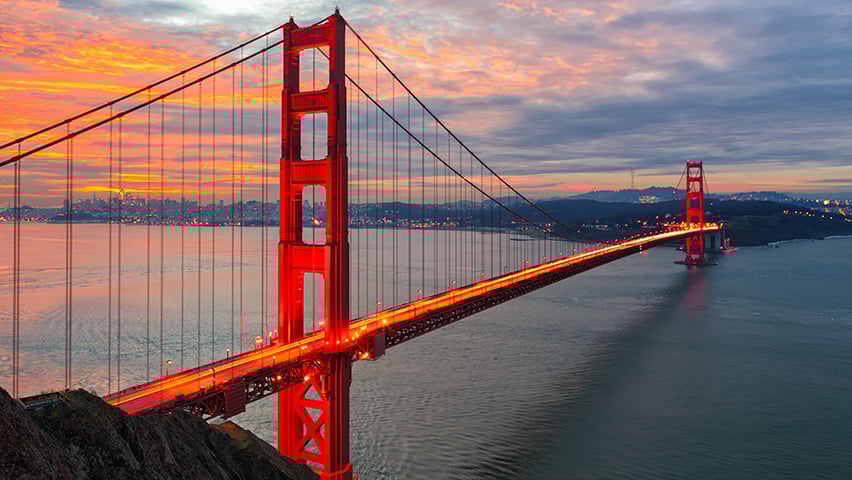 The sun rises over San Francisco and the Golden Gate Bridge
