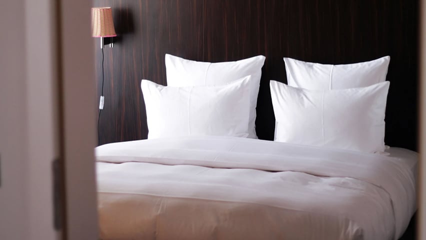 An image of a hotel bed in Seattle.