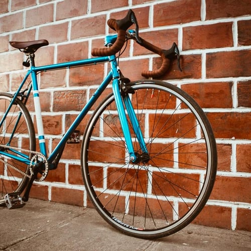 Bicycle leaning against brick wall
